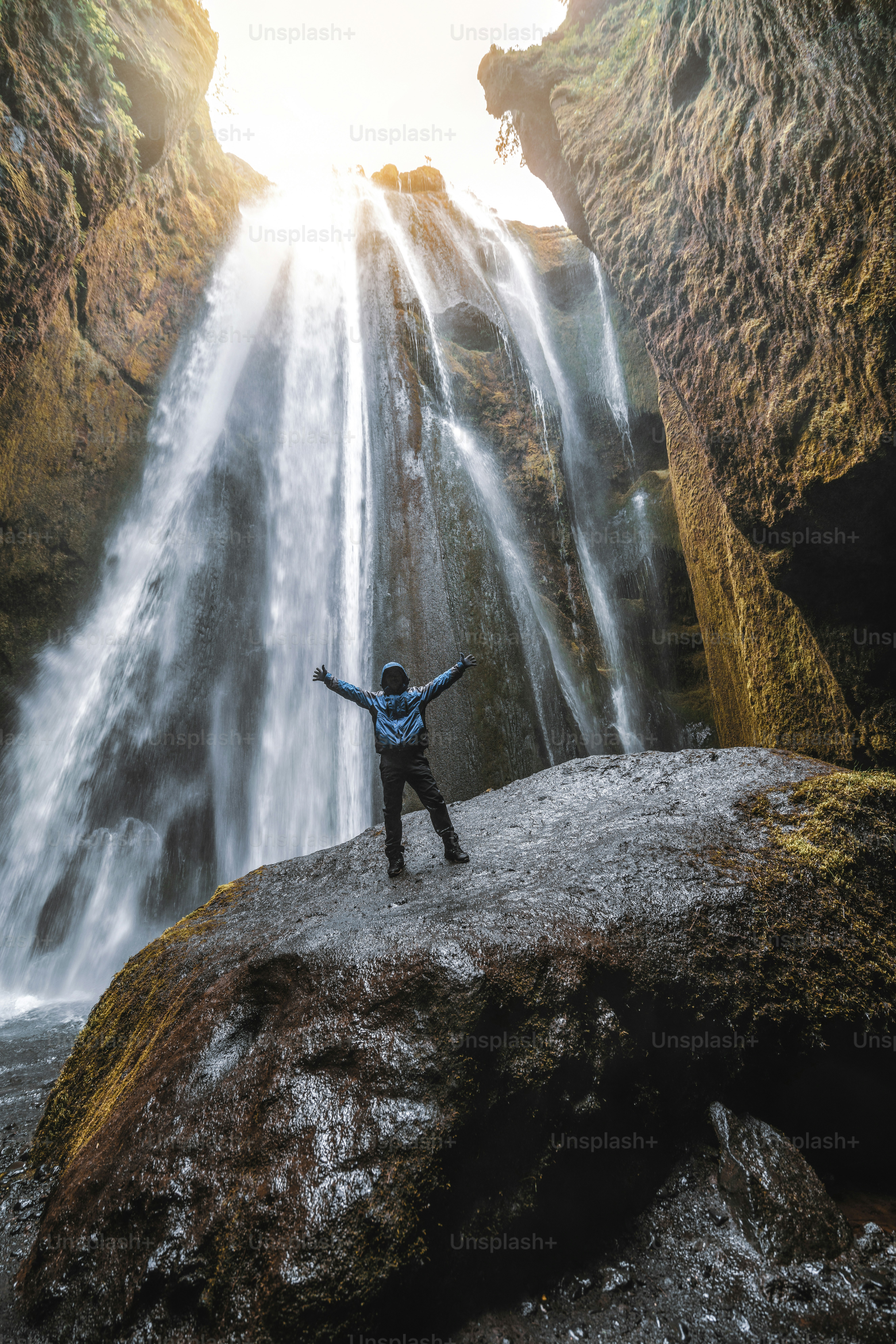 Traveler stunned by Gljufrabui waterfall cascade in Iceland. Located at scenic Seljalandsfoss waterfall South of Iceland, Europe. It is top beautiful destination of popular tourist travel attraction.