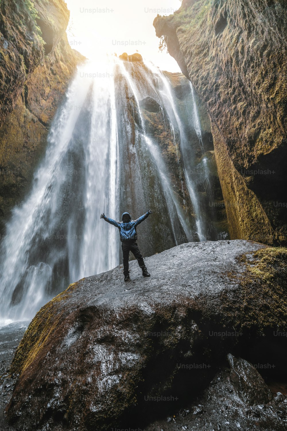 Traveler stunned by Gljufrabui waterfall cascade in Iceland. Located at scenic Seljalandsfoss waterfall South of Iceland, Europe. It is top beautiful destination of popular tourist travel attraction.