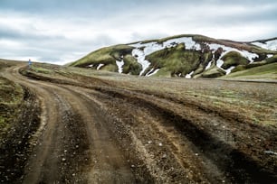 Beautiful Landmanalaugar gravel dust road way on highland of Iceland, Europe. Muddy tough terrain for extreme 4WD 4x4 vehicle. Landmanalaugar landscape is famous for nature trekking and hiking.