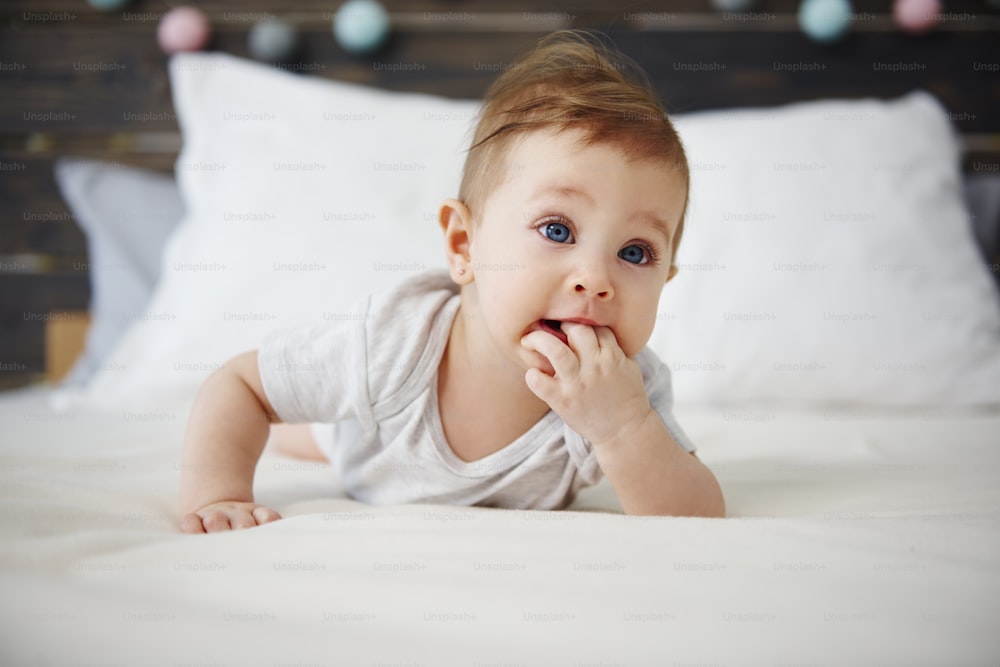 Portrait of baby lying on the bed