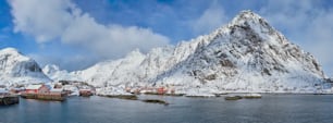 Panorama of traditional fishing village A on Lofoten Islands, Norway with red rorbu houses. With snow in winter