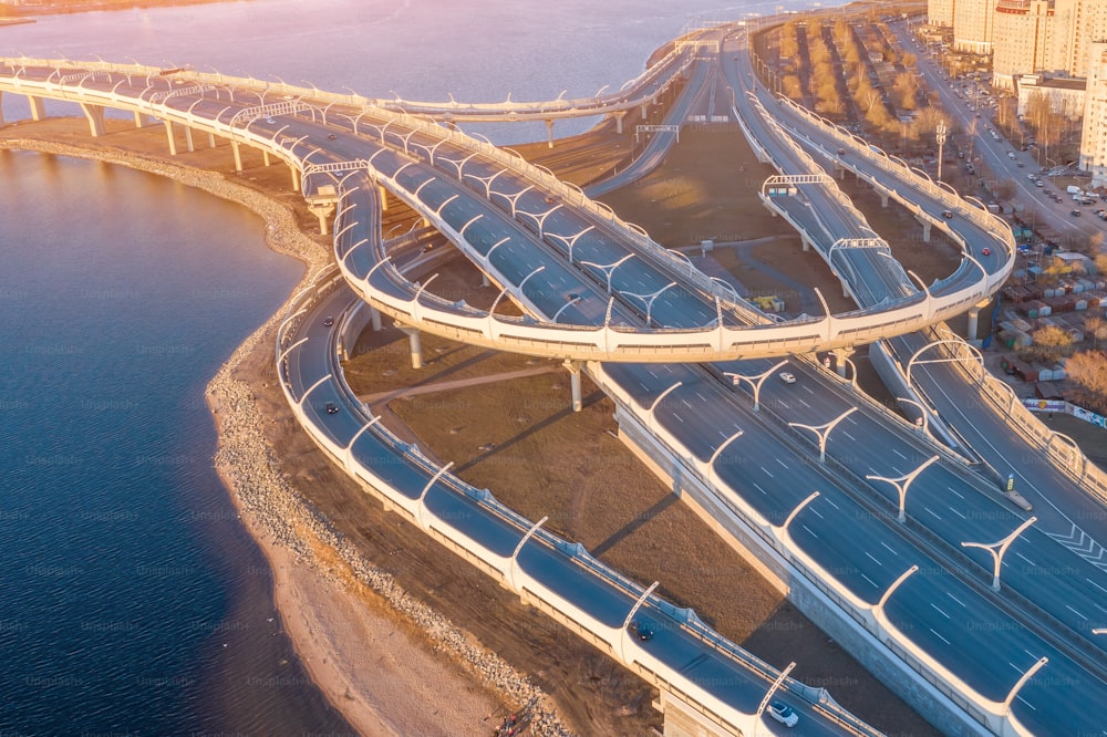 Aerial view highway loop over a road junction in the evening at sunset