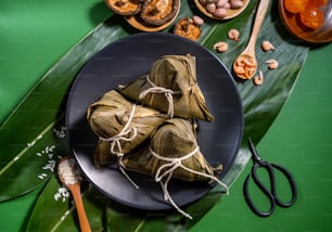 Close up, copy space, top view, flat lay. Famous asian chinese tasty handmade food in duan wu festival, steamed rice dumplings shaped like pyramidal ingredients