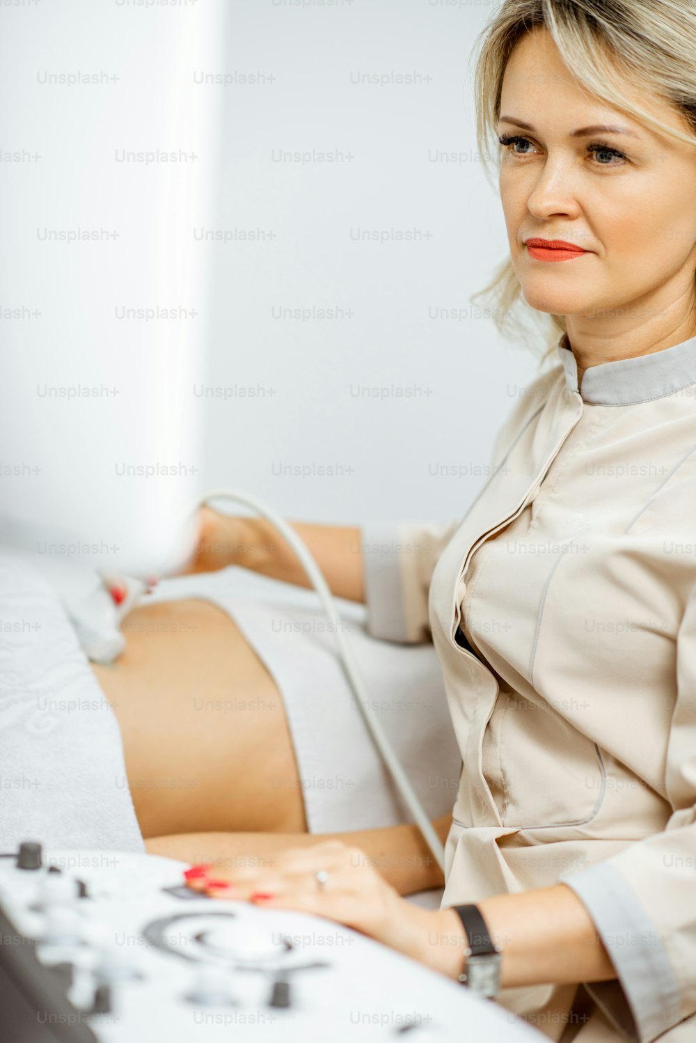 Ärztin führt Ultraschalluntersuchung der Beckenorgane einer Frau durch oder diagnostiziert eine frühe Schwangerschaft in der Arztpraxis