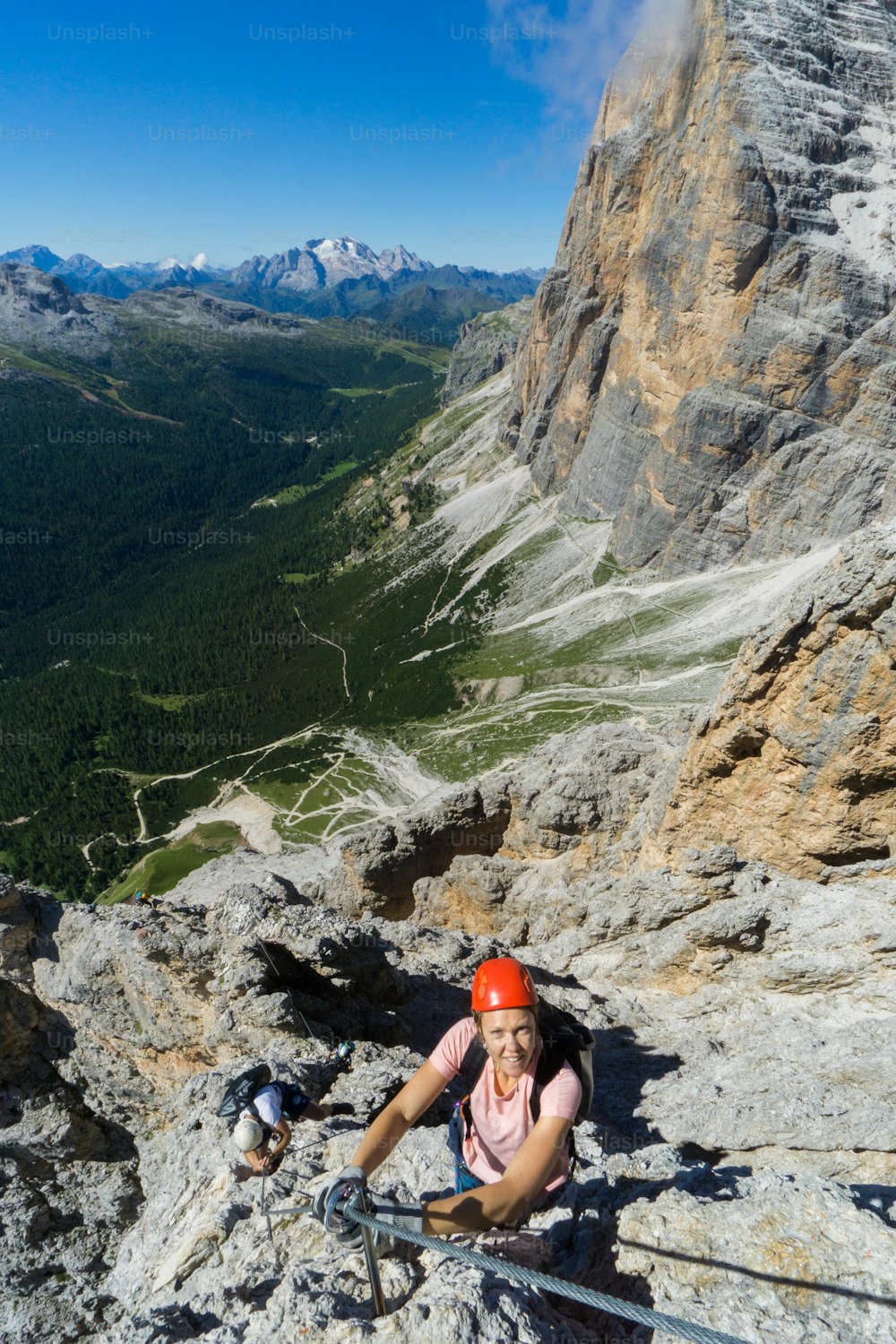 two young mountain climbers on very exposed Via Ferrata in Alta Badia in the Italian Dolomites