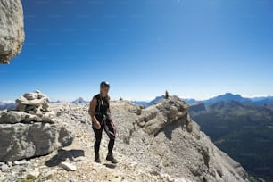 grimpeuses randonnant le long d’une crête sommitale rocheuse dans les Dolomites d’Italie après être sorties d’une voie d’escalade