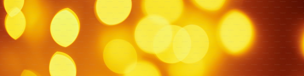Background of golden lights in bokeh. Defocused abstract blurred lights