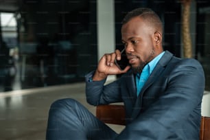 Corporate executive Black African businessman having serious conversation on mobile phone