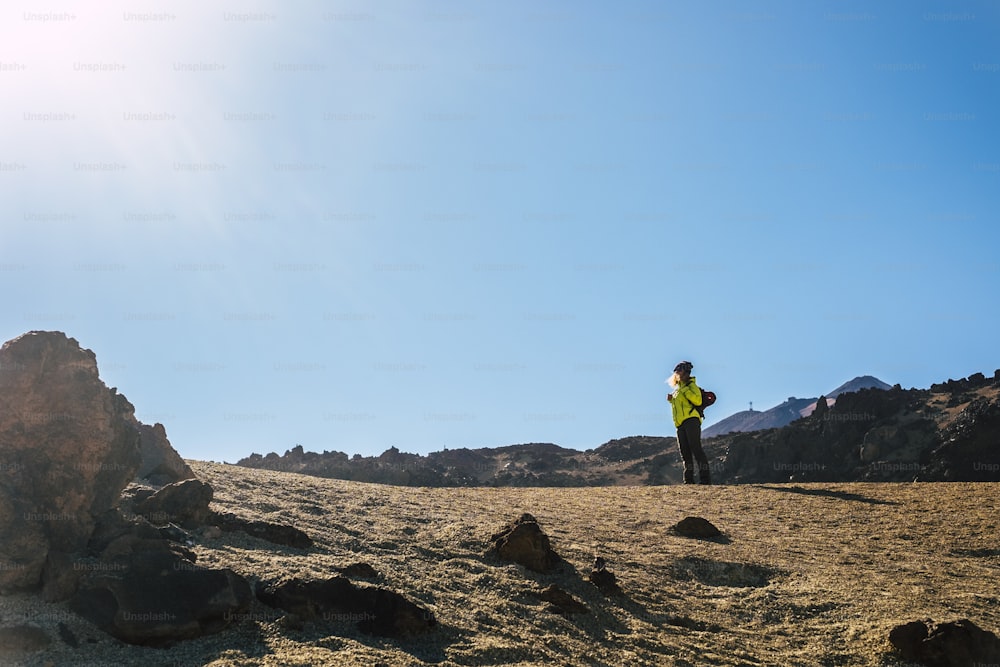 Standing woman enjoying the outdoor leisure activity in. mountain. active healthy lifestyle expedition - alternative people in sport hiking active life - lonely traveler in the desert