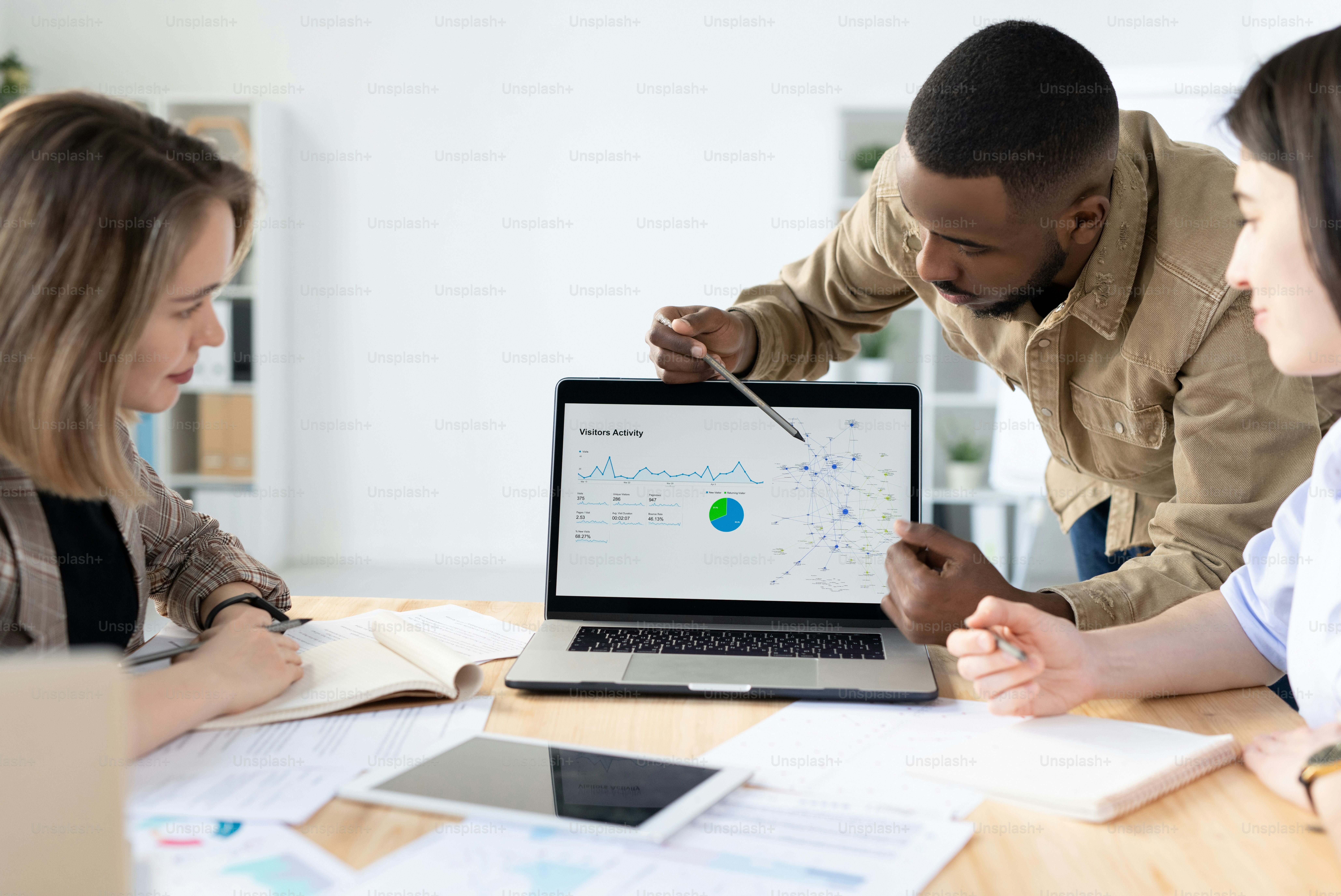 Business professionals discussing marketing statistics in a meeting