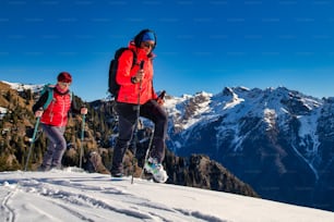 Pair of women practice mountaineering in the snow