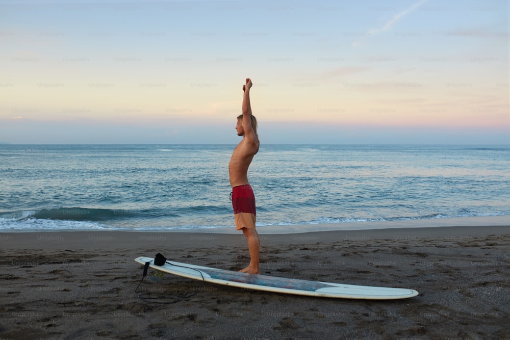 Surfing Man. Stretching Surfer On Sandy Beach Going To Surf On Surfboard. Water Sport For Active Lifestyle At Beautiful Sea.