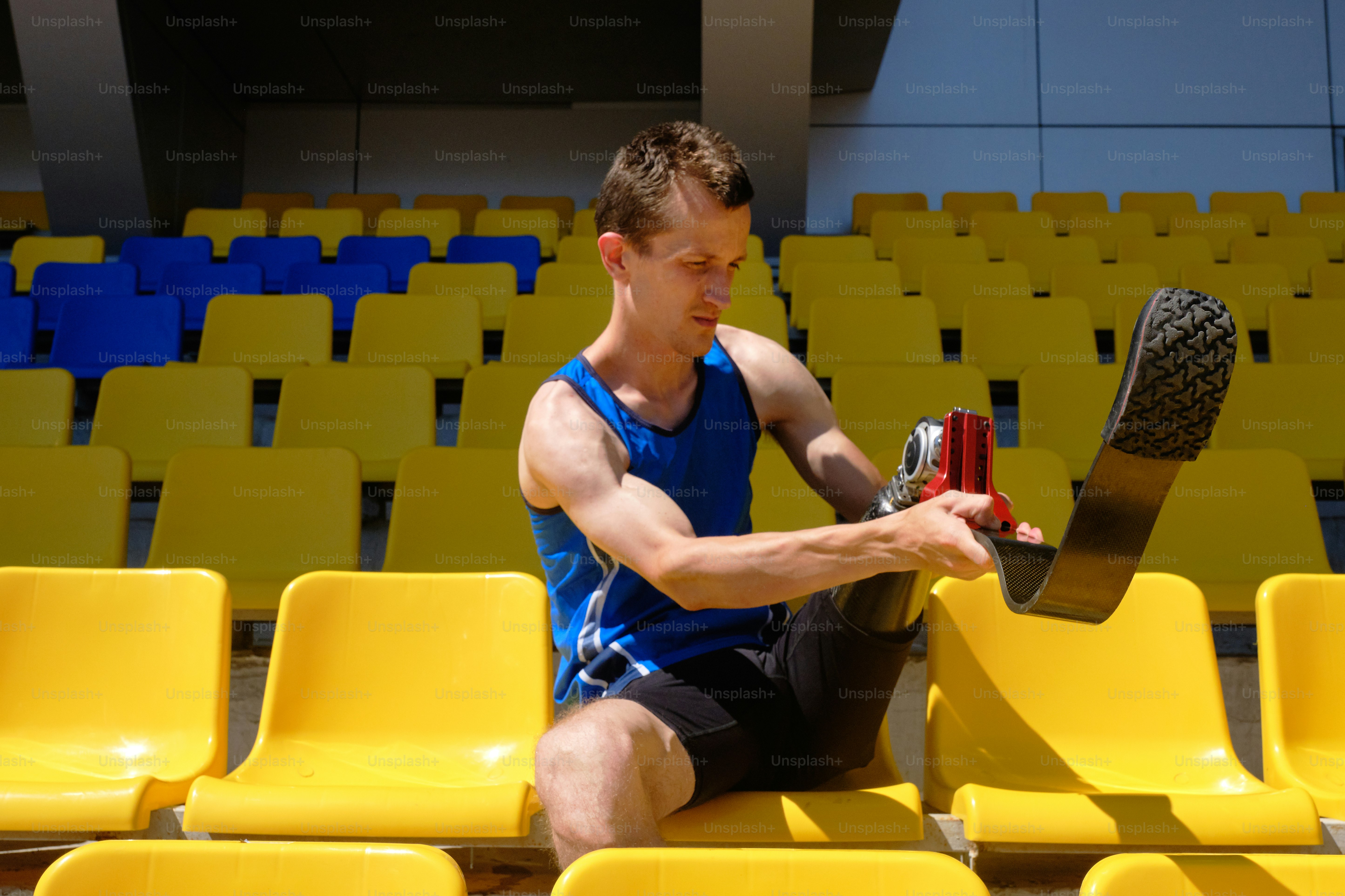 Portrait of adaptive athlete with prosthetic foot fixing equipment ...