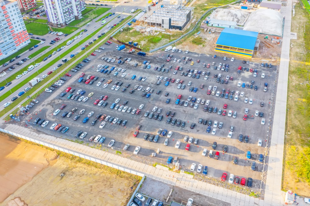 Dealership parking lot, many cars top aerial view