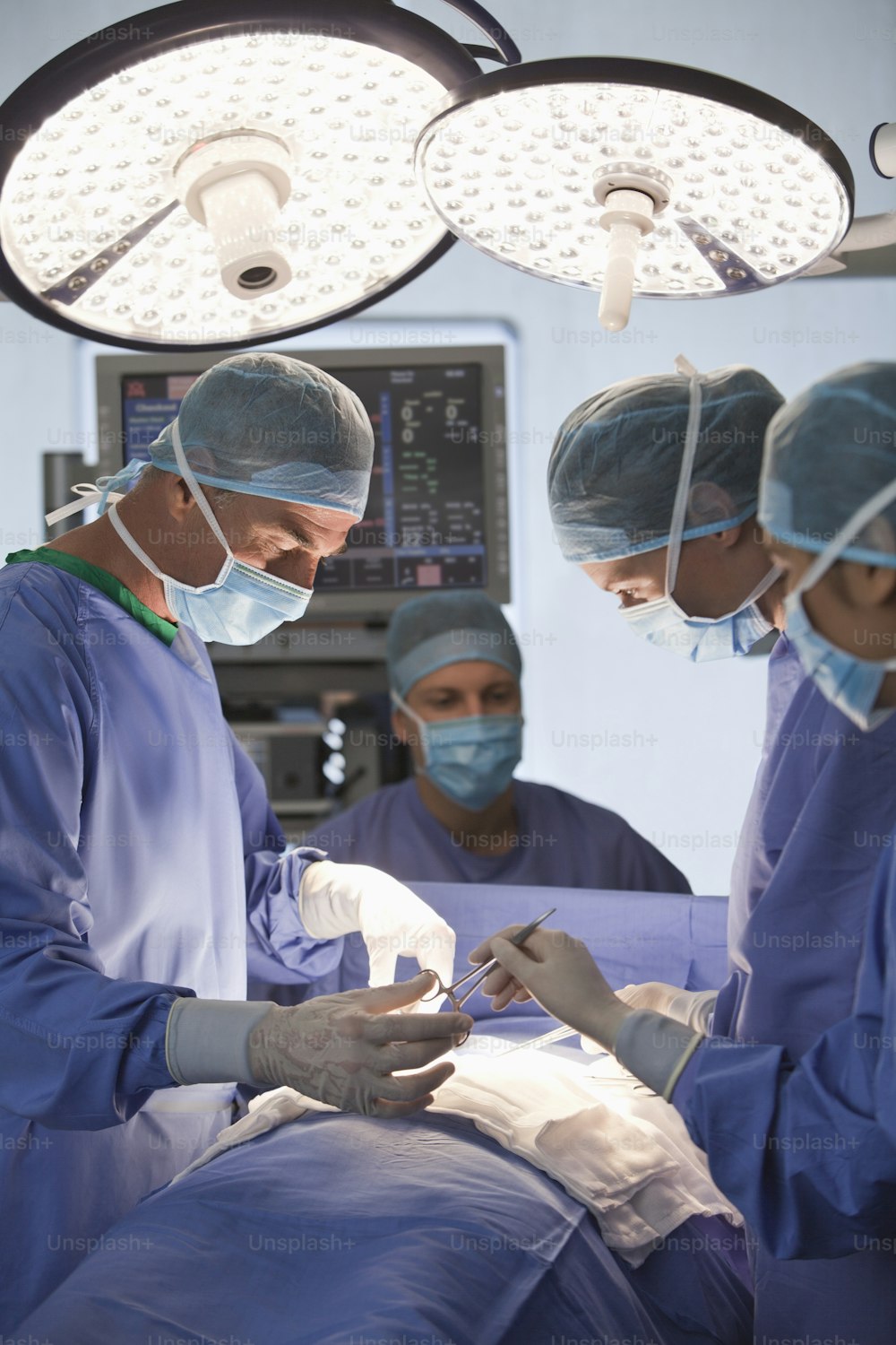 a group of doctors performing surgery in a hospital