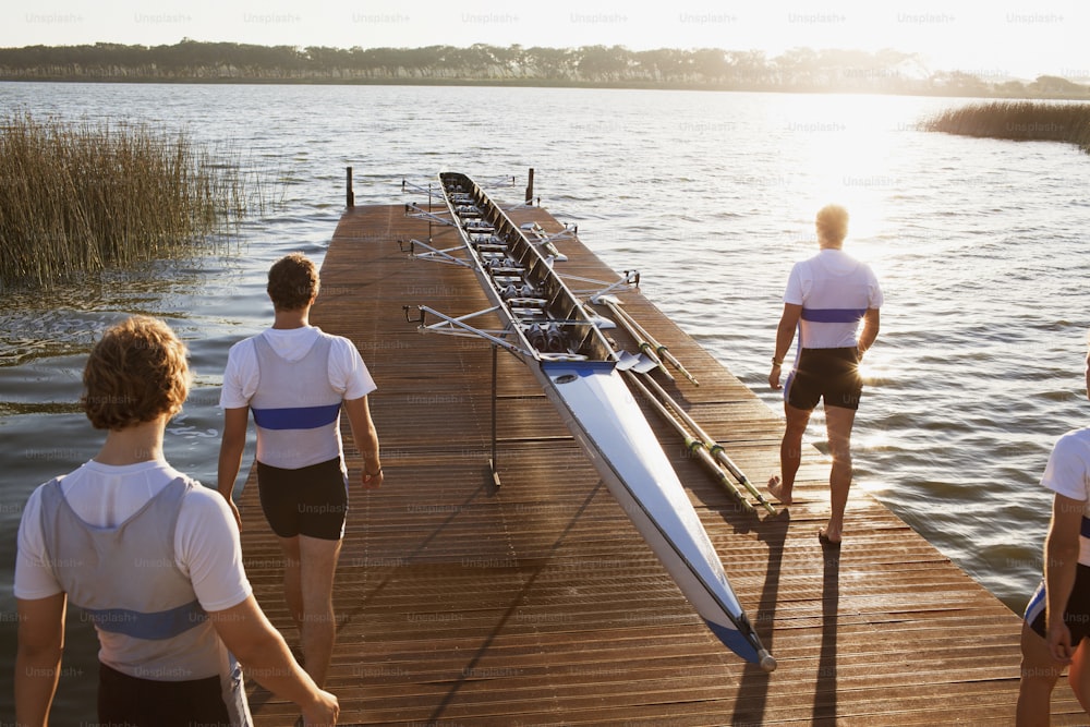 a group of people standing on a dock next to a boat