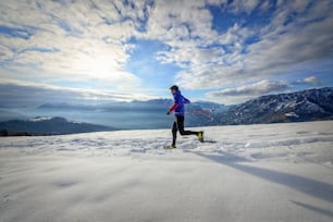 Immersed in alpine nature with snowshoes at sunset