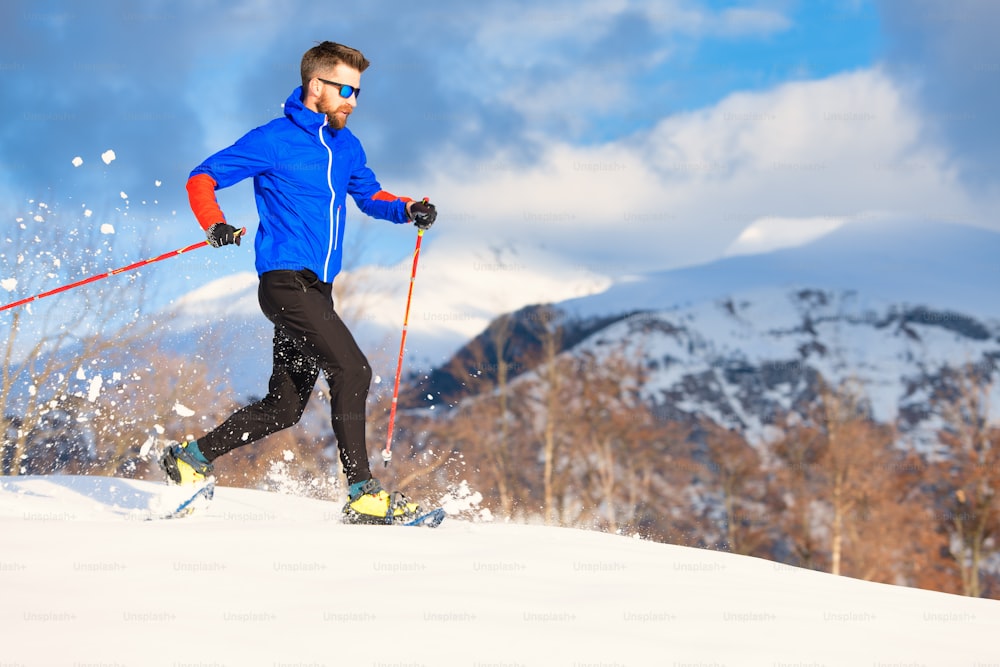 A man athlete trains for running with snowshoes