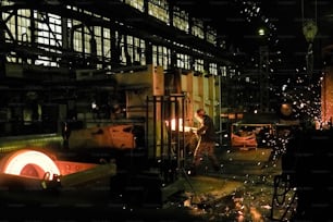 People welding the metal during work in metal processing plant