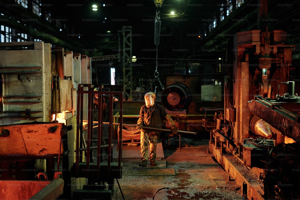 Group of workers working with metal in the factory