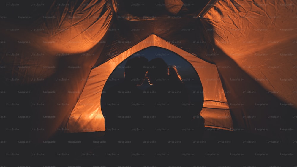 The young couple sitting in the night campsite