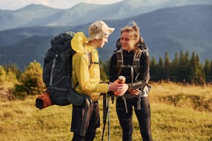 In adventure together. Cute couple. Majestic Carpathian Mountains. Beautiful landscape of untouched nature.