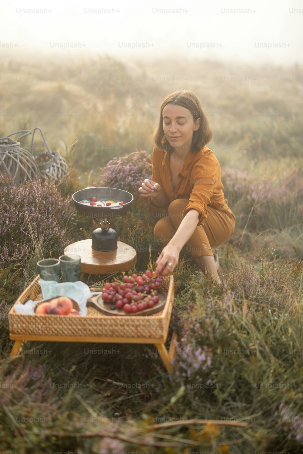Mulher viajante tem um belo tempo berakfast com ovos e frutas enquanto viaja em montanhas em tempo nebuloso