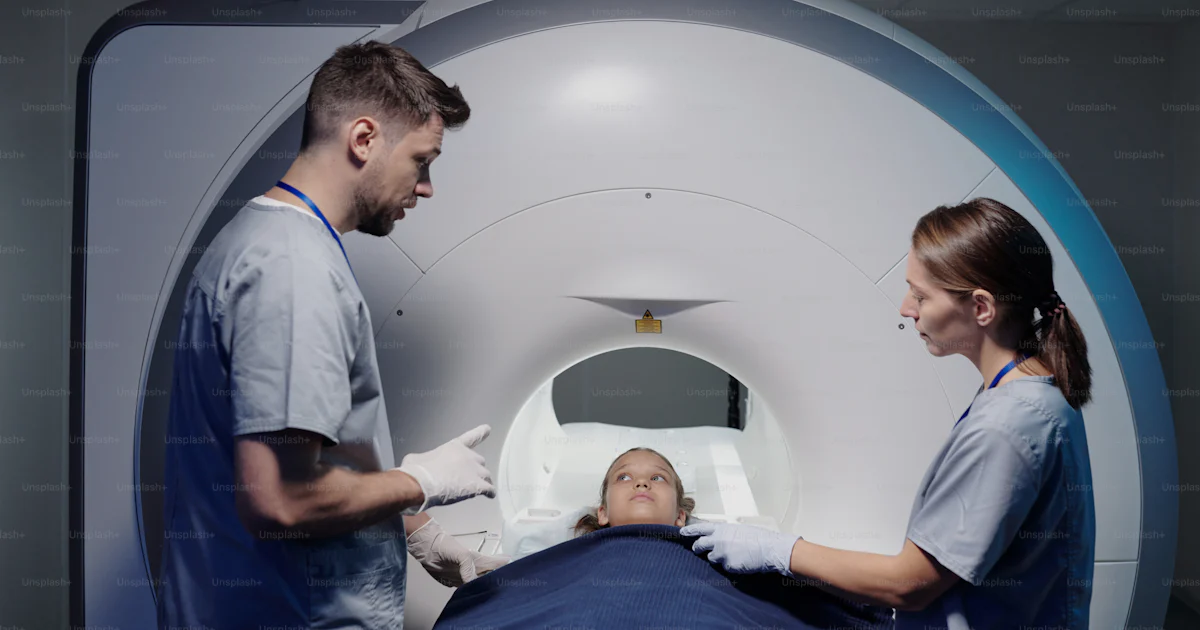Mri Plus One of two radiologists consulting little patient before examination on ...