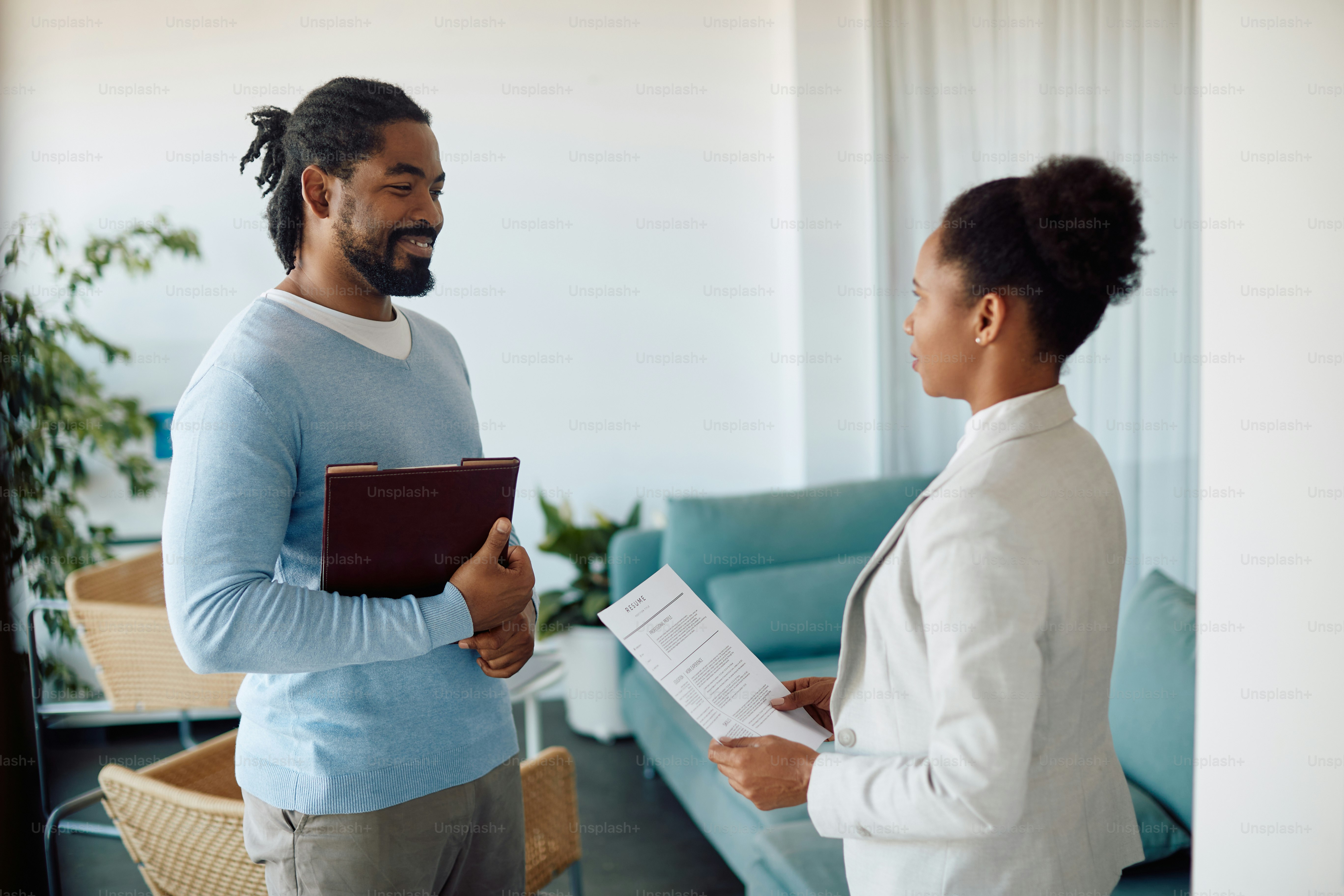 Happy African American candidate talking businesswoman while having job ...