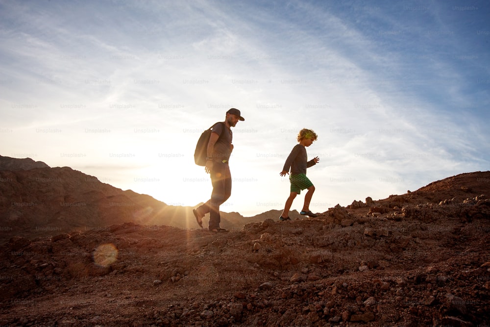 Dad with son in the mountains in the desert