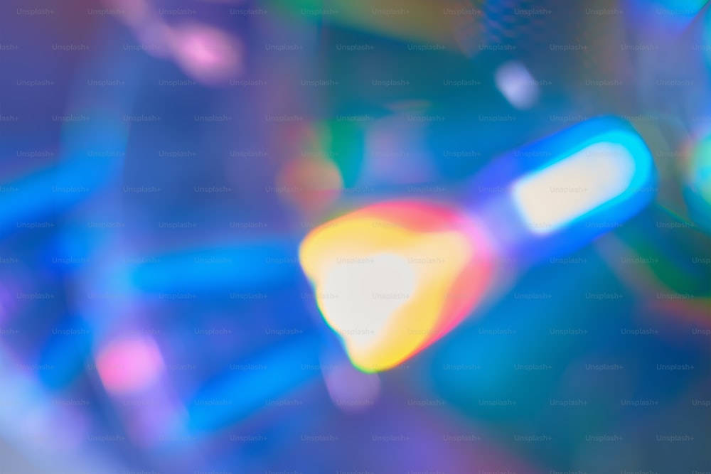 Defocused film texture background with colored lights on dark background. Blurred rainbow color light flare for photo effects