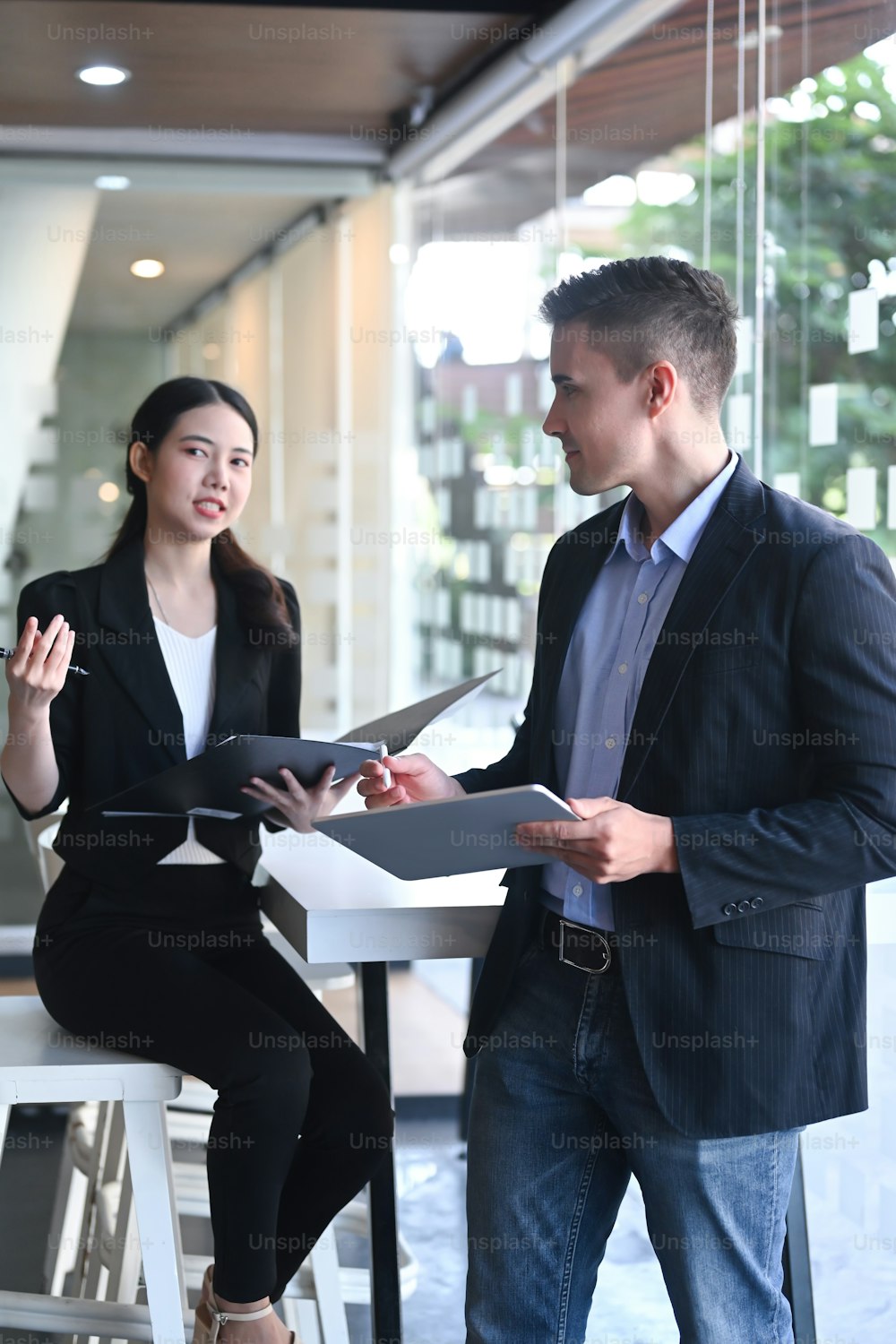 Attractive businesswoman explaining information to her colleague.
