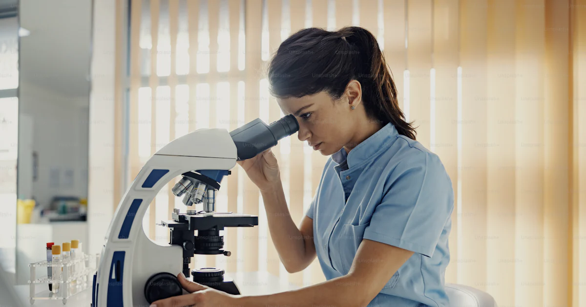 Asad Lab Assistant A lab assistant in lab using microscope for tests. Medical support, lab ...
