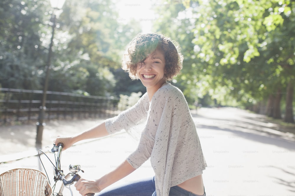 a woman riding a bike down a street