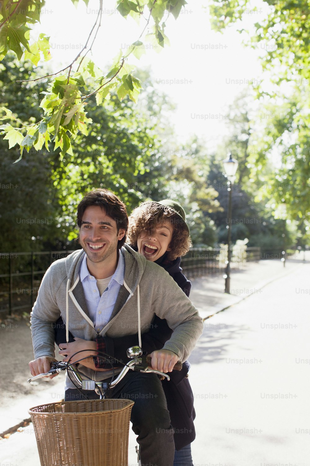 a man and a woman riding a bike together