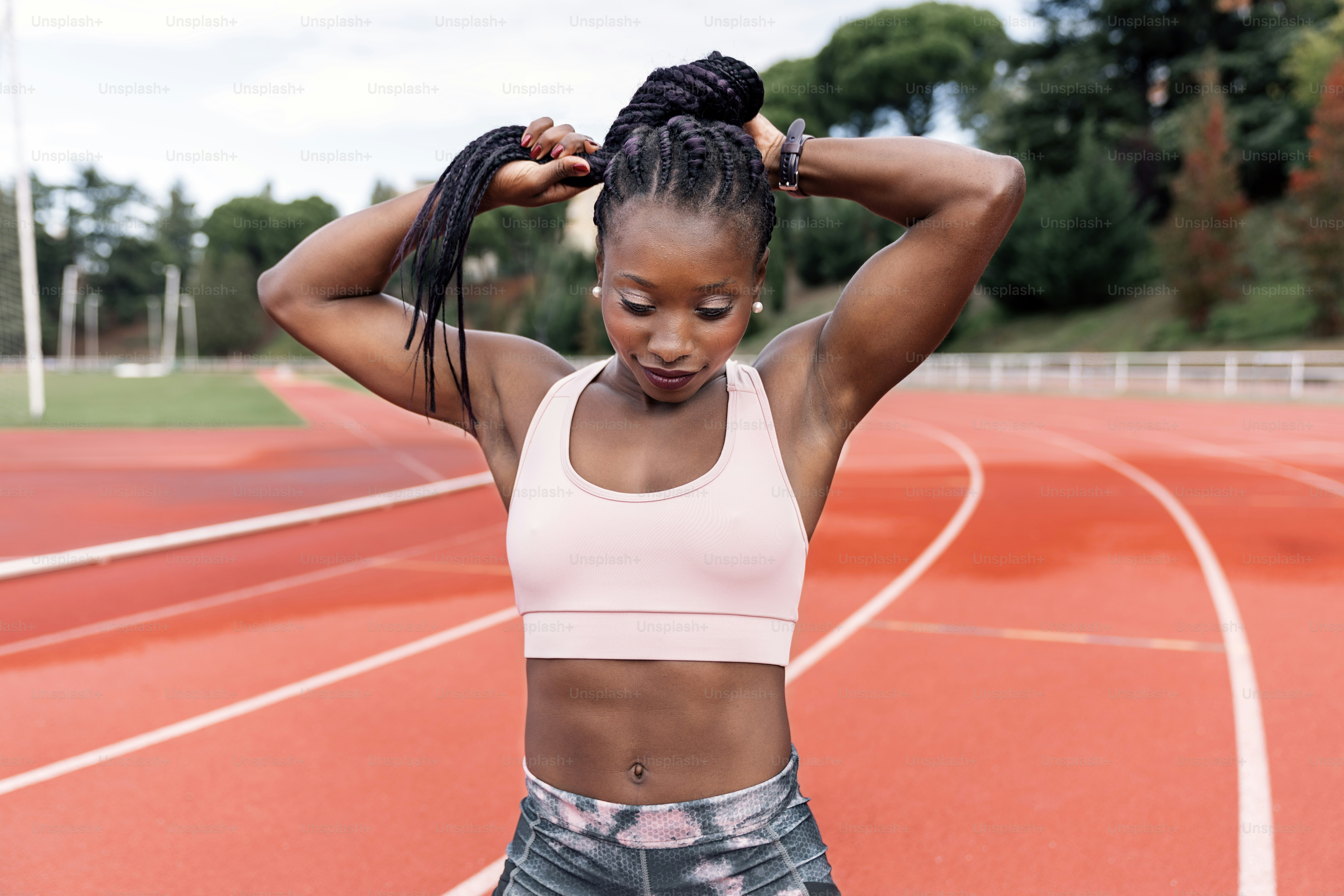 Stock photo of an African-American sprinter standing on an athletics ...
