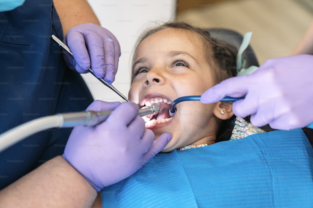 Stock photo of cute little girl during revision at the dentist.