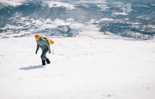 Hiker wearing gaiters climbing mountain in the winter.