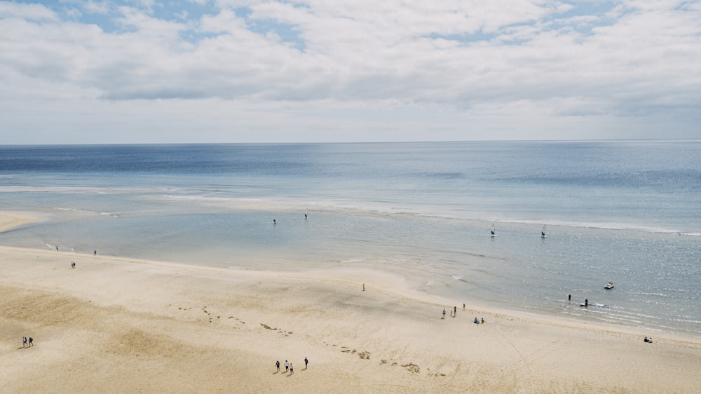 Above view of sand beach and blue ocean and sky with tourists people enjoying travel and summer holiday vacation. Blue sea water. Caribbean landscape