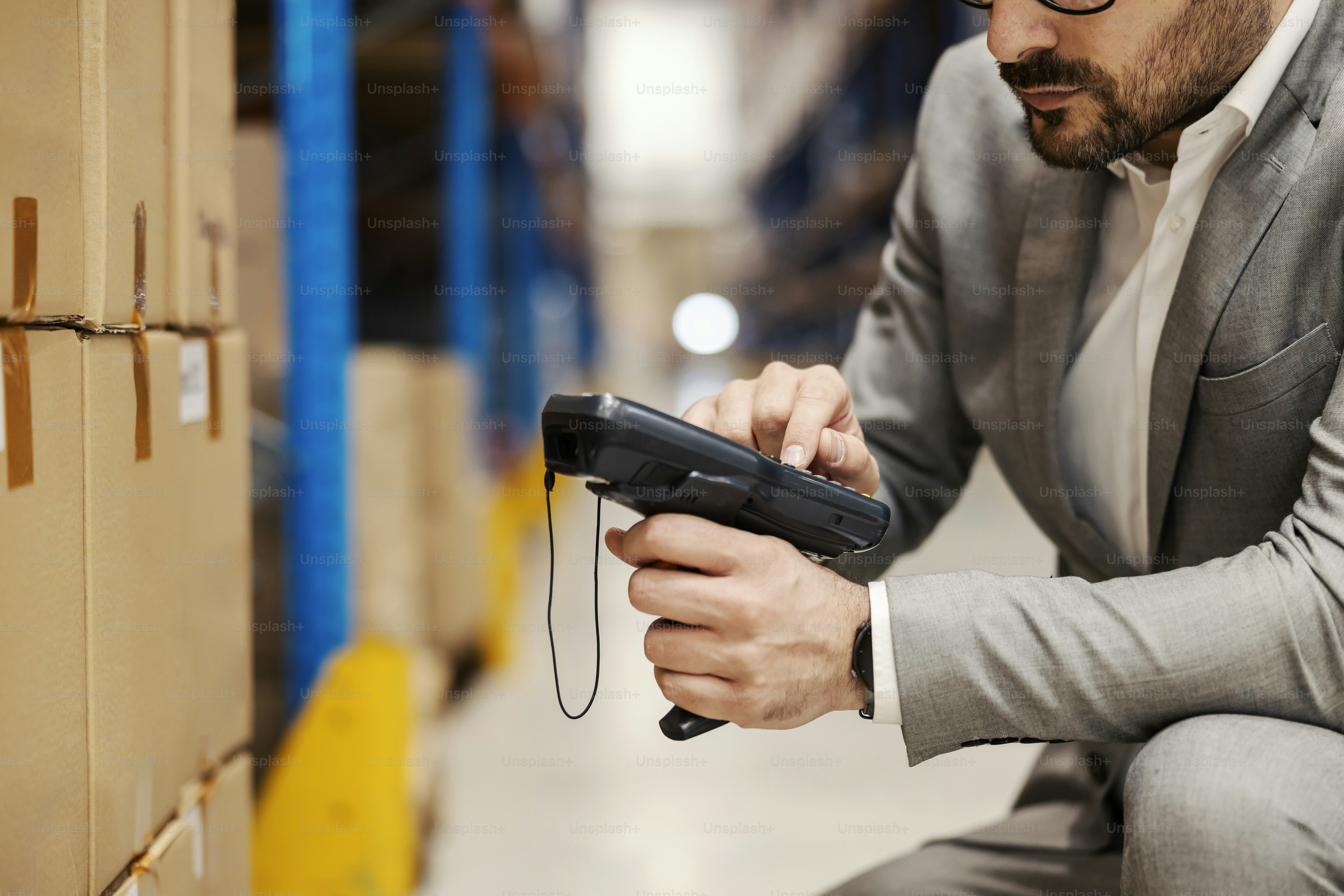 Close up of an inspector using scanner in storage.