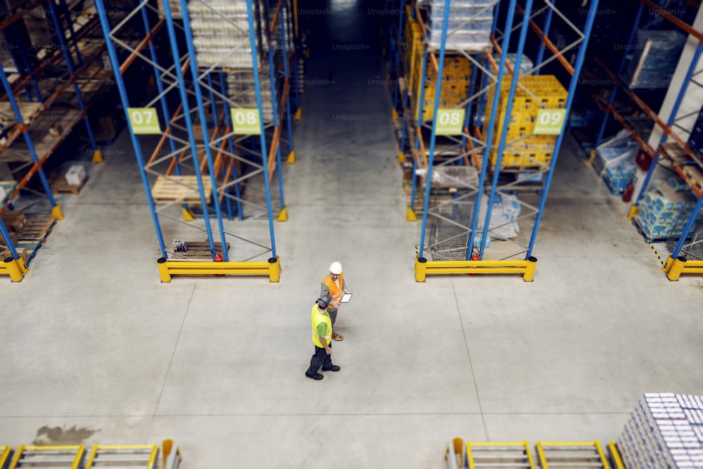 Top view of a manager walking around with warehouse worker.