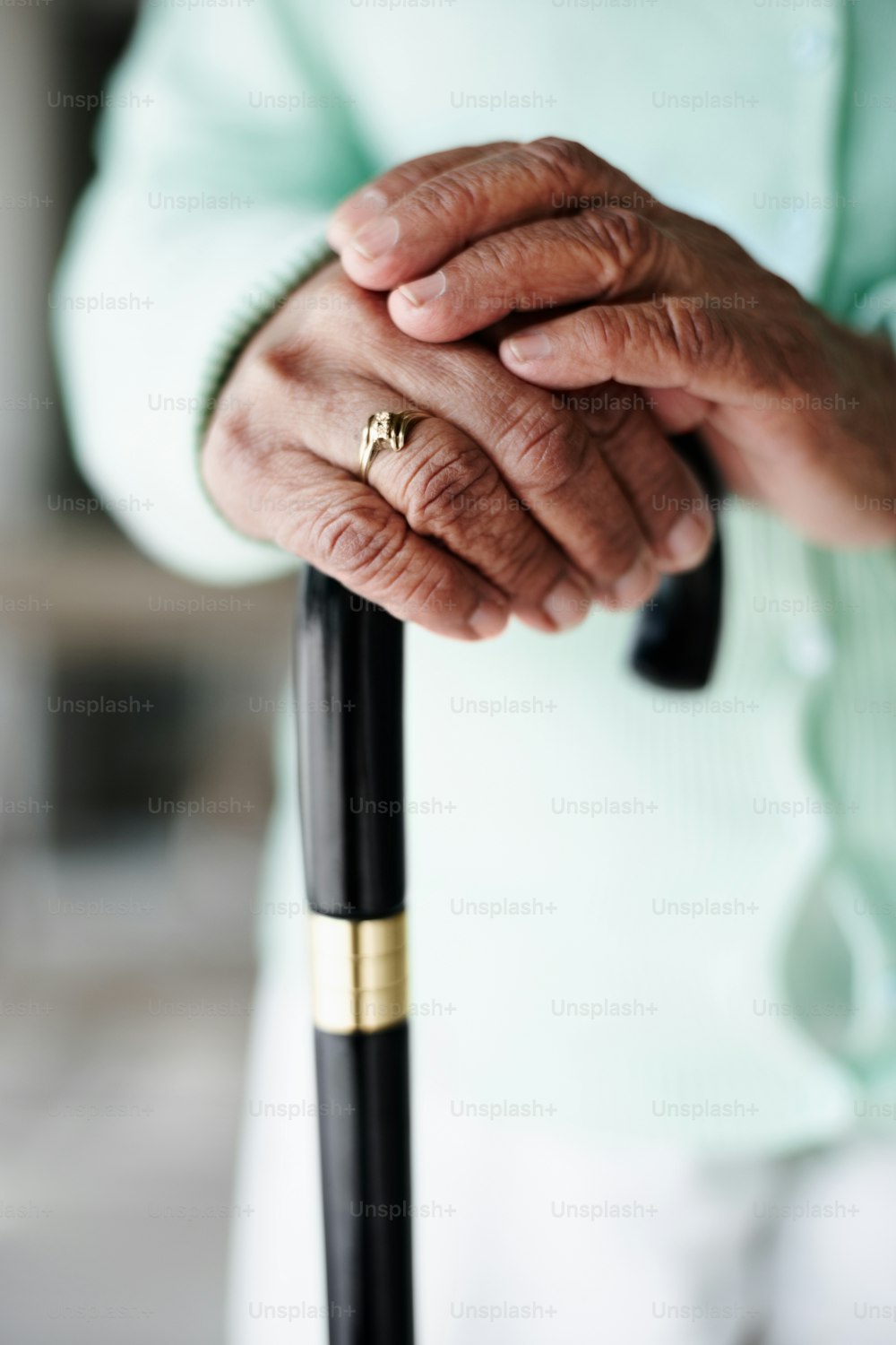 Close-up of senior woman's hands on walking stick