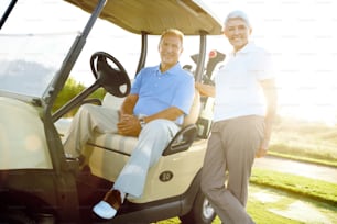 "A senior couple enjoying a round of golf on a crisp, bright morning"