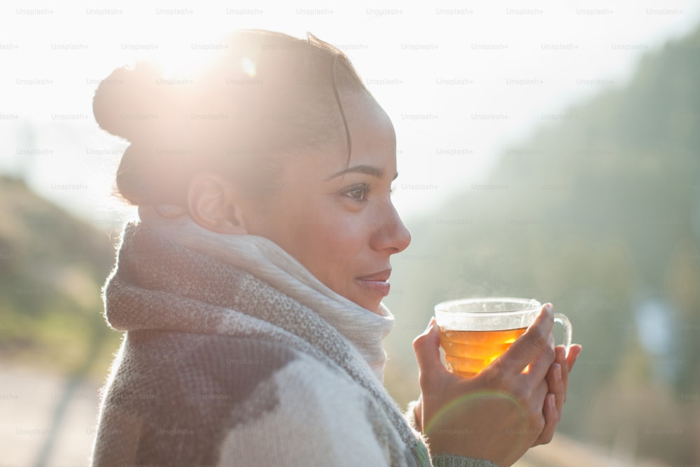 a woman is holding a glass of tea