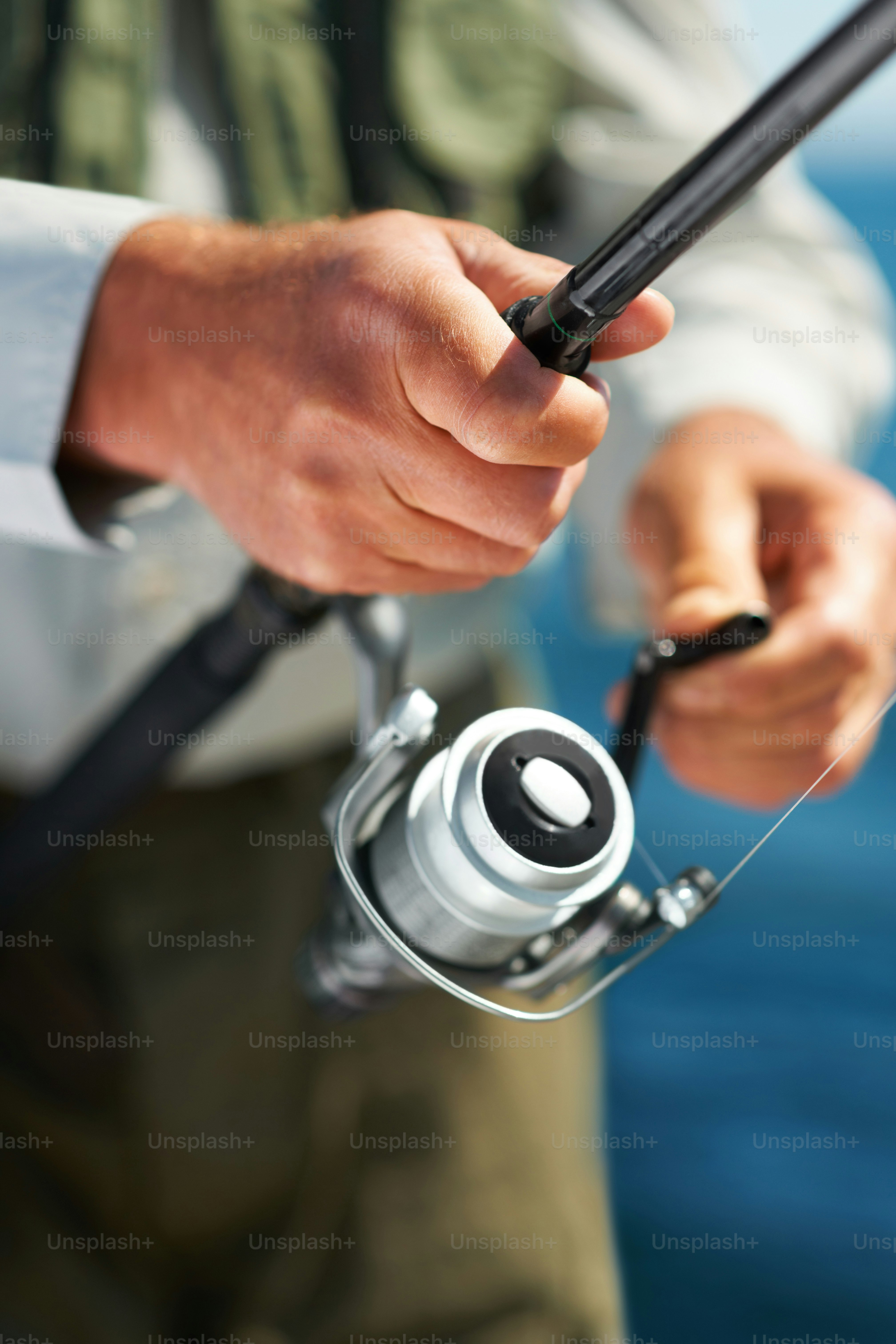 a man holding a fishing rod and a reel
