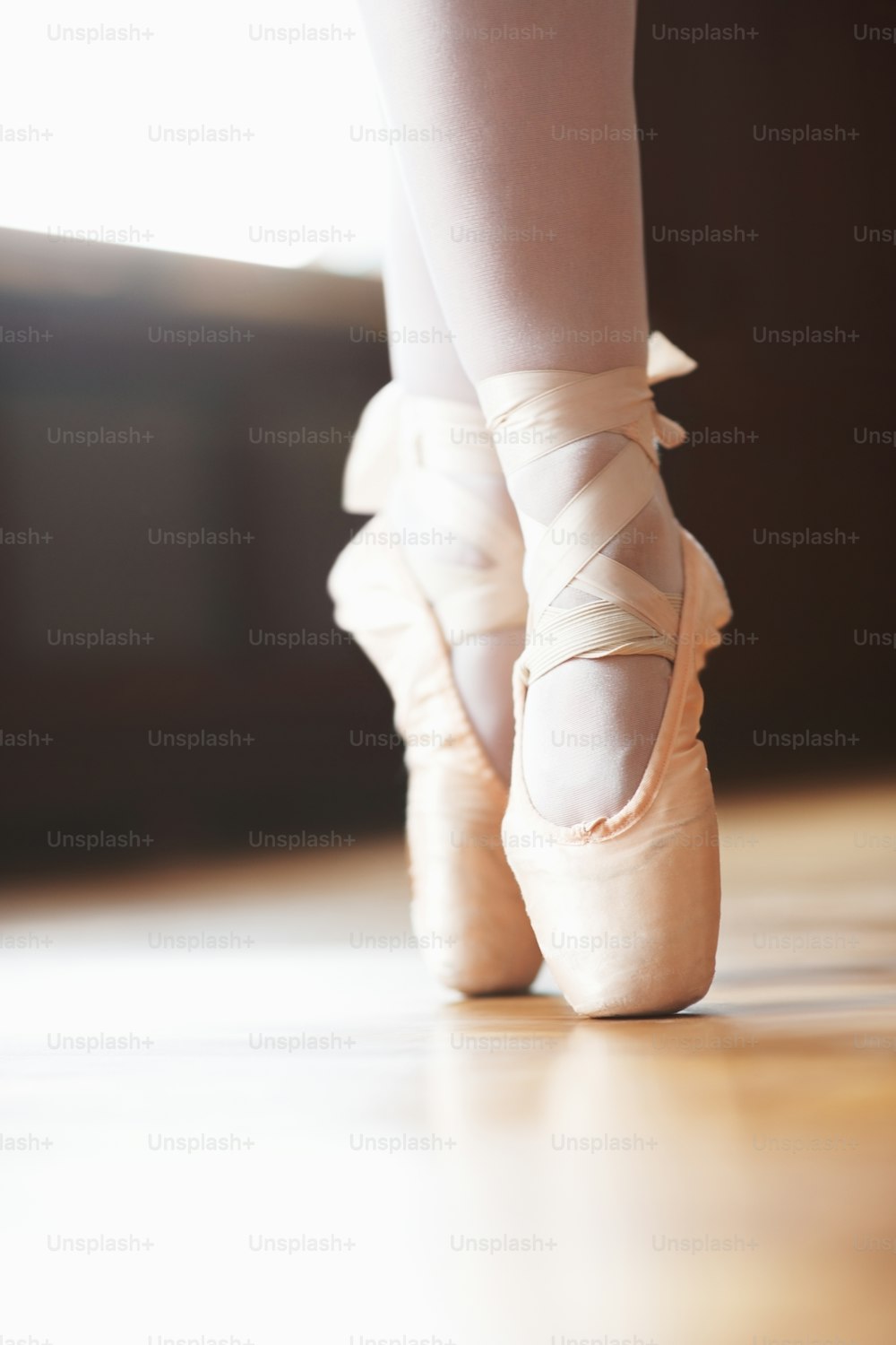 a close up of a person's feet wearing ballet shoes