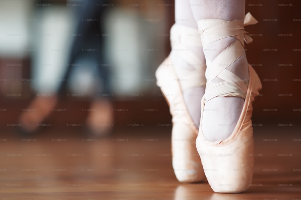 a close up of a person's feet wearing ballet shoes