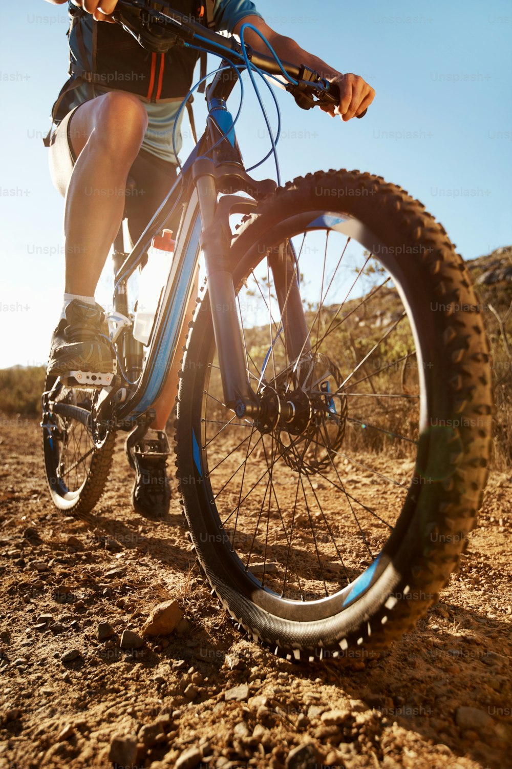 Mountain biker sitting on bike in country environment on a sunny day