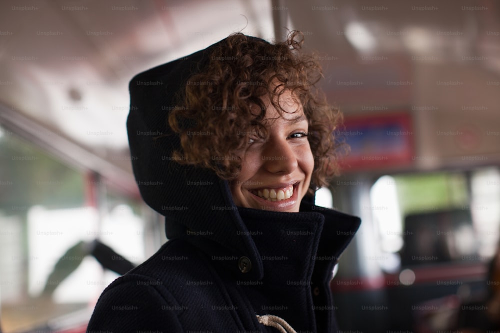 a woman with curly hair wearing a hoodie