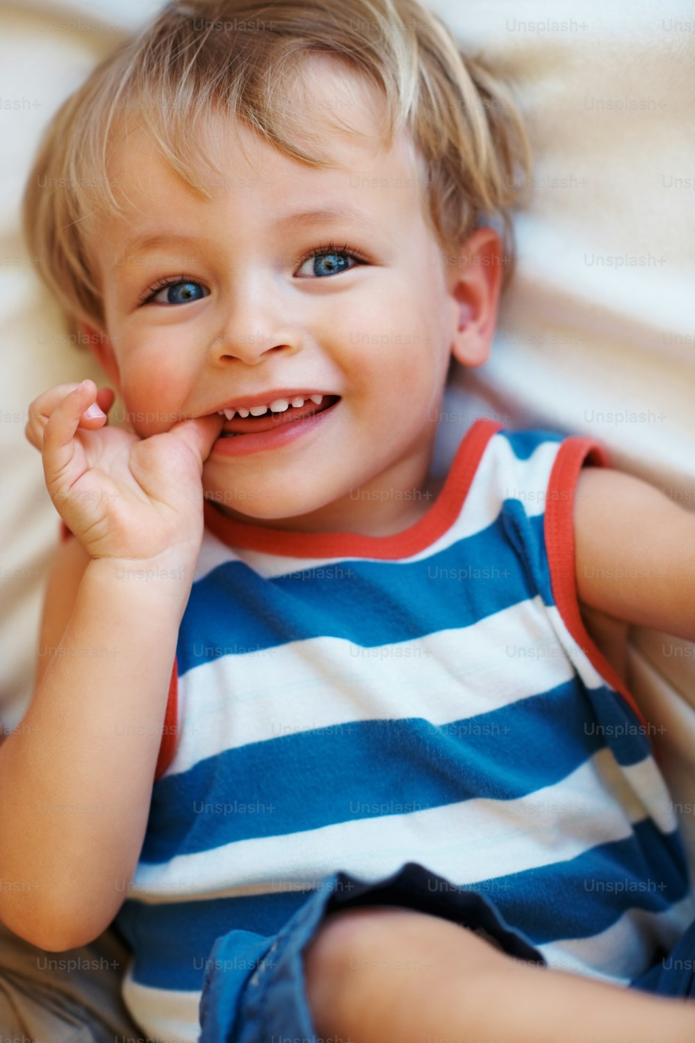 a little boy that is laying down on a bed